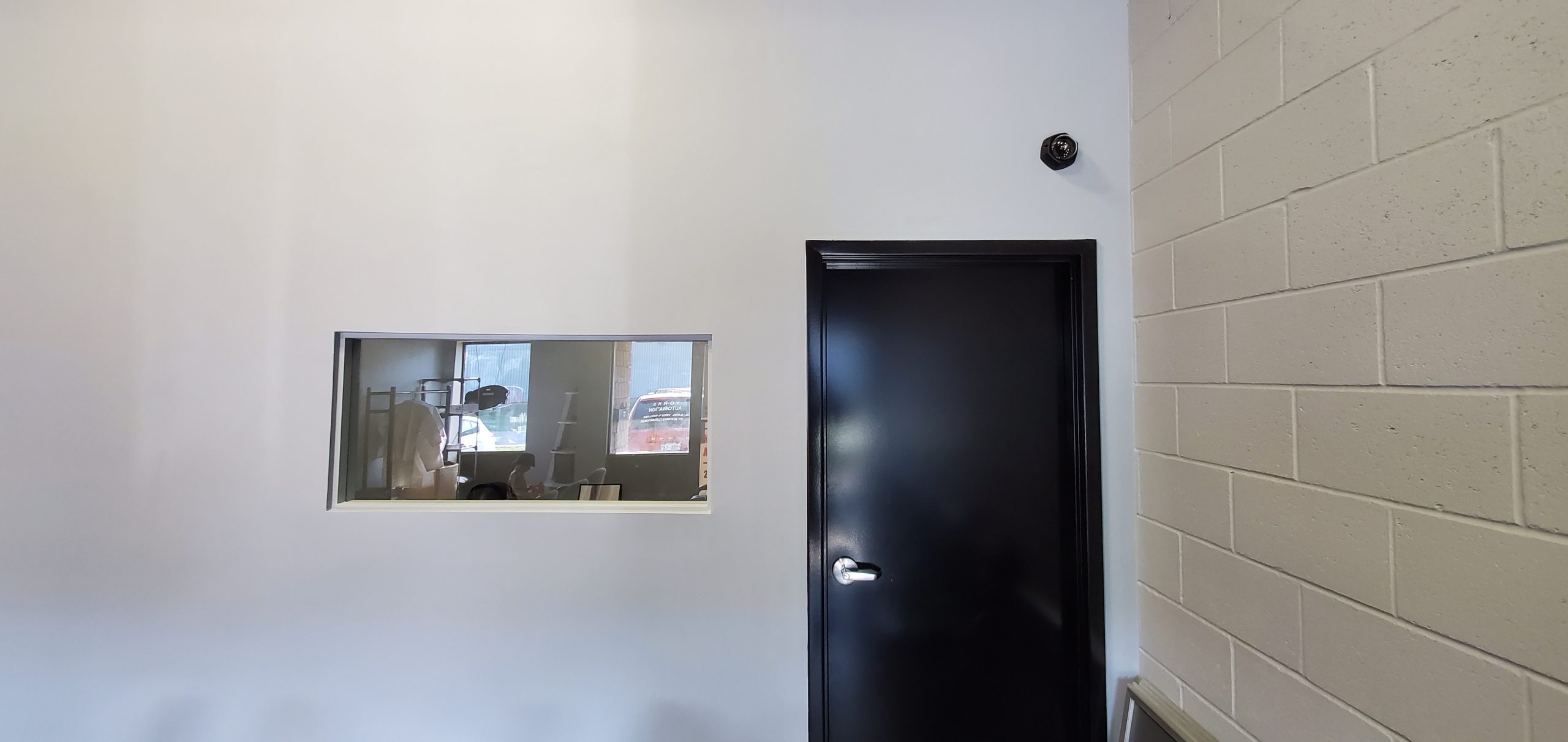Commercial entrance with a wall-mounted security camera