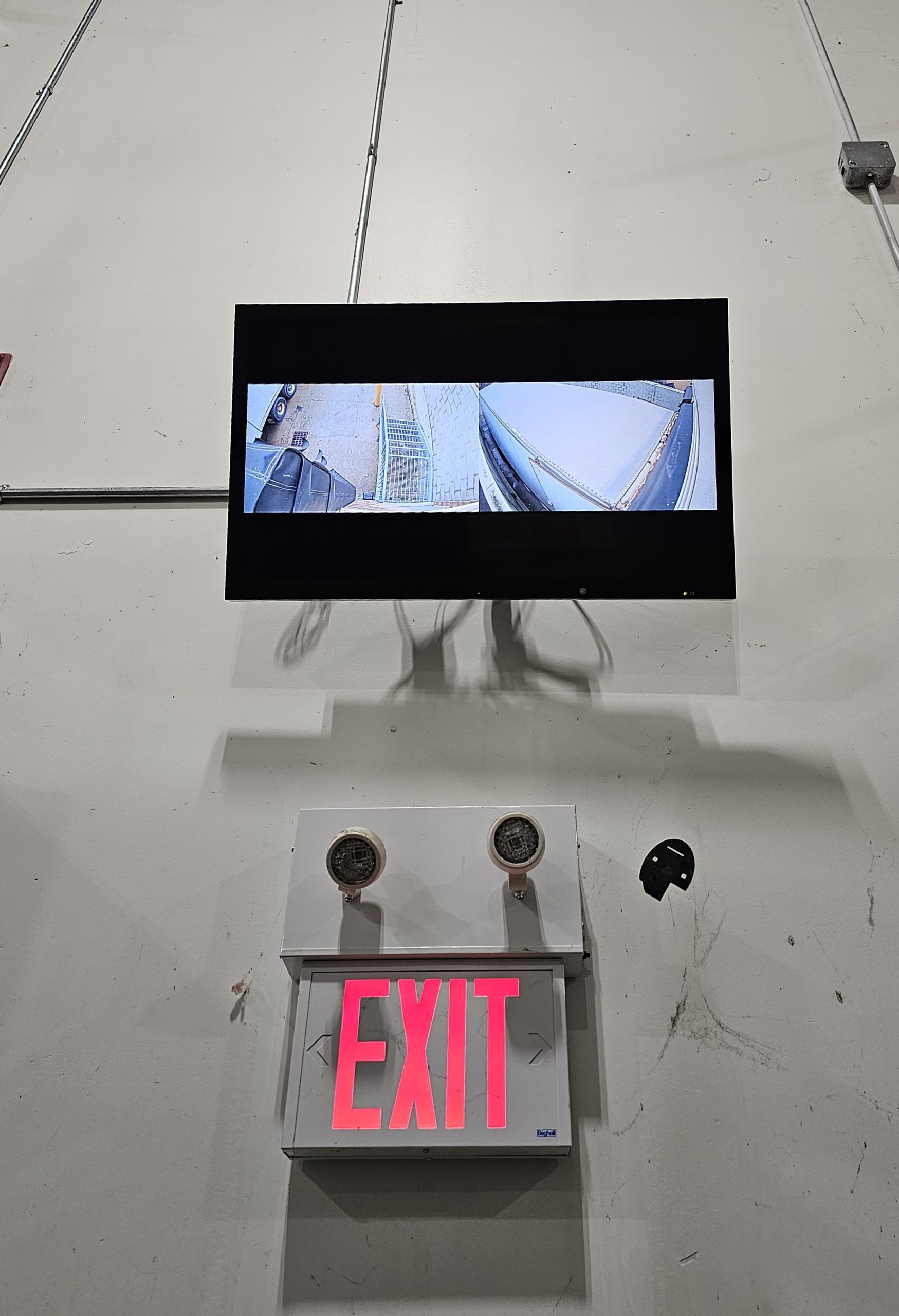 Wall-mounted security monitor above an exit