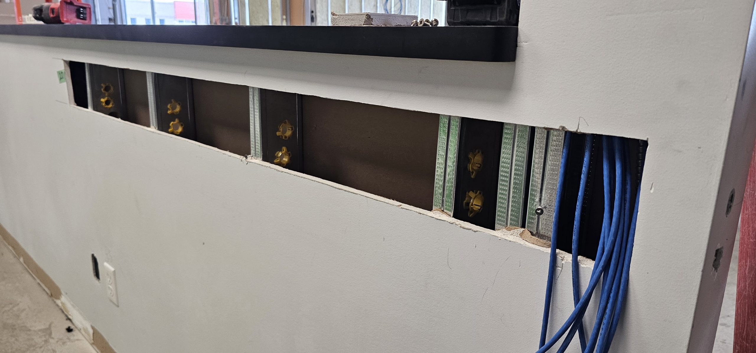 Low-voltage cabling routed within an unfinished wall